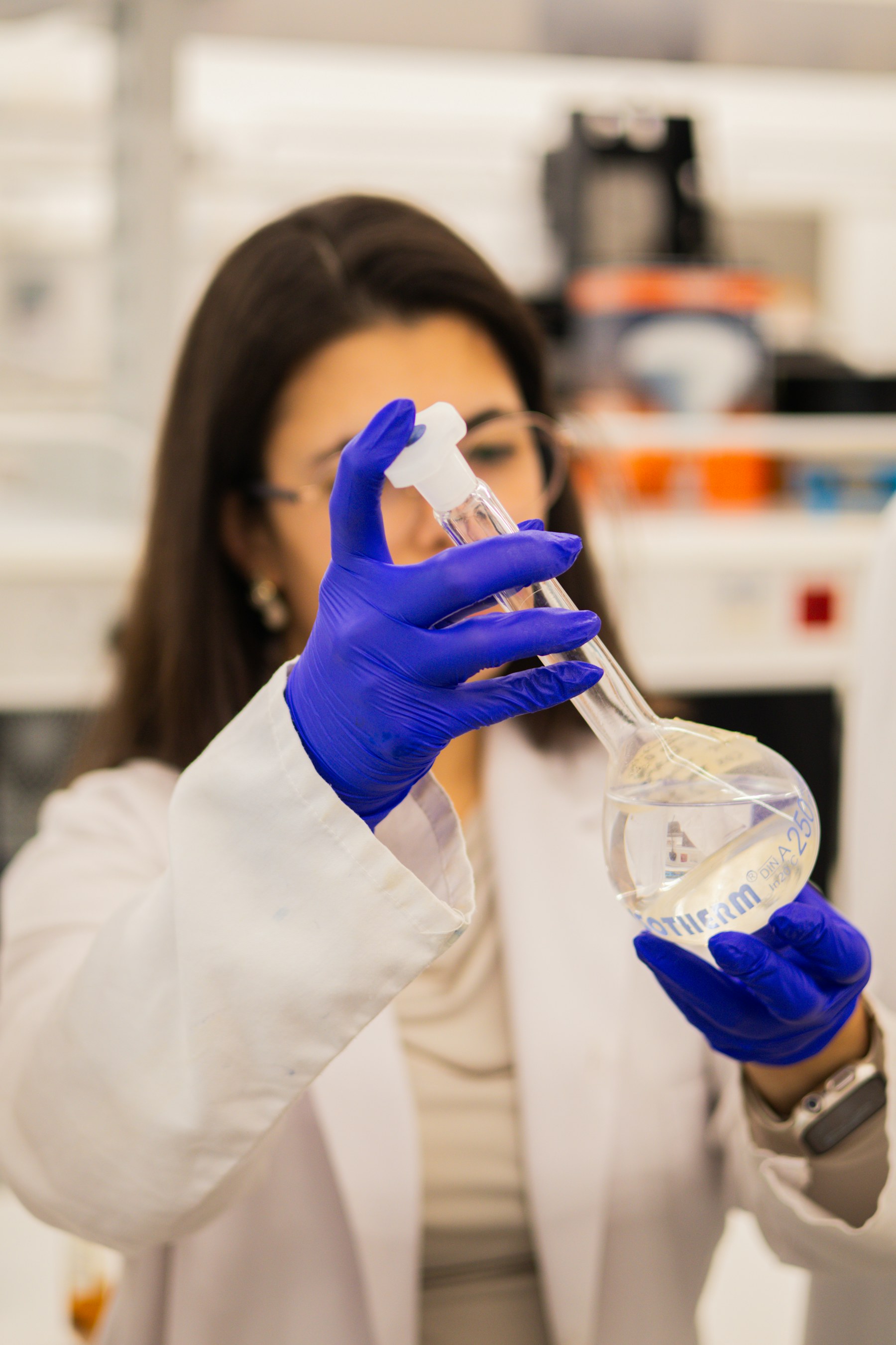 Scientist evaluating a liquid formulation in a laboratory